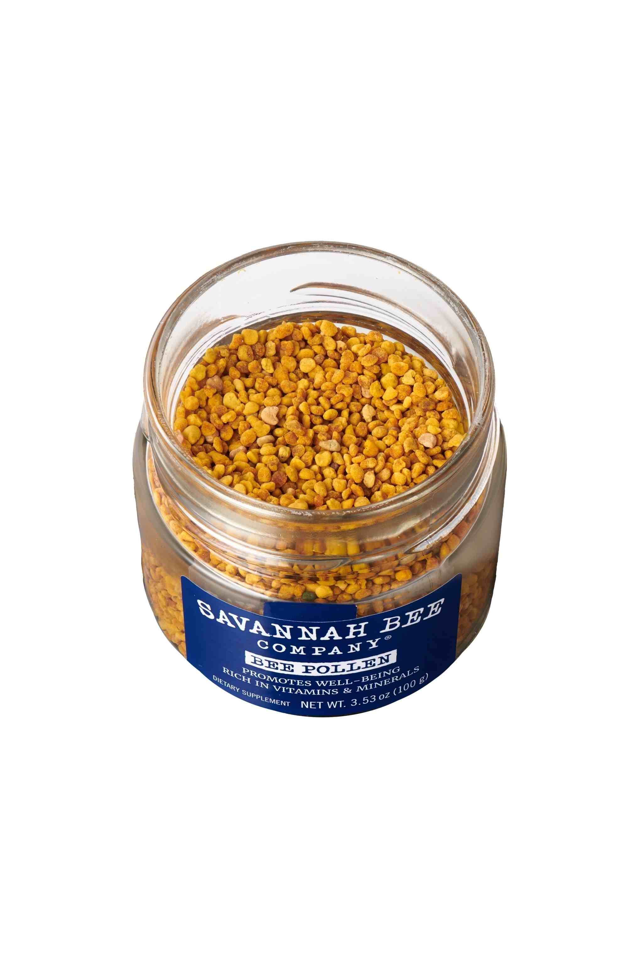 Pure & Natural Savannah Bee Company Bee Pollen 3.53. oz. Lid unscrewed with a ariel shot of bee pollen.